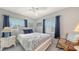 Cozy bedroom featuring natural light from two windows, a ceiling fan, and a comfortable rocking chair at 3647 Lake Bayshore Dr # 416, Bradenton, FL 34205