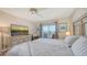 Relaxing bedroom with a view of the beach on television and sliding glass door to the balcony at 3647 Lake Bayshore Dr # 416, Bradenton, FL 34205