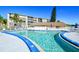 Resort-style community pool with ample lounge seating and views of the surrounding buildings at 3647 Lake Bayshore Dr # 416, Bradenton, FL 34205
