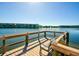 Lakeside dock with a chair overlooking a scenic lake and apartment complex at 3647 Lake Bayshore Dr # 416, Bradenton, FL 34205