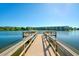 Wooden pier with railings overlooking a scenic lake and apartment complex at 3647 Lake Bayshore Dr # 416, Bradenton, FL 34205