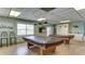 Game room with two billiard tables, natural light, and a coffee bar area for community enjoyment at 3647 Lake Bayshore Dr # 416, Bradenton, FL 34205