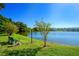 Scenic lakeside view showcasing a bench, streetlamp, and tranquil waters, perfect for relaxation at 3647 Lake Bayshore Dr # 416, Bradenton, FL 34205