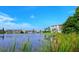 Scenic view of the lake and lakeside condos with beautiful blue sky backdrop at 3647 Lake Bayshore Dr # 416, Bradenton, FL 34205
