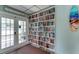 Community library with a floor-to-ceiling bookcase and nearby access to an outdoor patio at 3647 Lake Bayshore Dr # 416, Bradenton, FL 34205