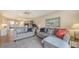 Spacious living room with gray sofas, wood-look flooring and lots of natural light at 3647 Lake Bayshore Dr # 416, Bradenton, FL 34205
