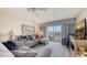 Comfortable living room with gray sofas and a view of the balcony and beach at 3647 Lake Bayshore Dr # 416, Bradenton, FL 34205