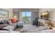 Living room area featuring gray sofa, rocker, area rug, and flat screen tv at 3647 Lake Bayshore Dr # 416, Bradenton, FL 34205