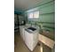 Well-lit laundry room with modern washer and dryer at 3921 Lakeside Rd # 168, Sarasota, FL 34232