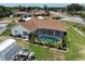 Aerial view of home's backyard featuring a screened-in pool and lush landscaping at 3984 Holin Ln, North Port, FL 34287
