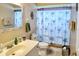 Cozy bathroom featuring a vanity sink, toilet, and palm tree shower curtain at 3984 Holin Ln, North Port, FL 34287