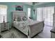 Bright bedroom features coastal decor, a ceiling fan, and sliding glass doors at 3984 Holin Ln, North Port, FL 34287