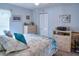 Comfortable bedroom with blue accents, dresser, closet, and beach themed decor at 3984 Holin Ln, North Port, FL 34287