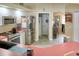 Modern kitchen with stainless steel appliances, white cabinetry, and wood-look flooring at 3984 Holin Ln, North Port, FL 34287