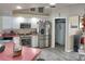 Well-equipped kitchen with white cabinets, stainless steel appliances and adjacent dining space at 3984 Holin Ln, North Port, FL 34287