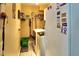 Functional laundry room with washer, dryer, and ample storage shelving at 3984 Holin Ln, North Port, FL 34287