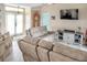 Relaxing living room featuring comfortable sofas, a large TV, and sliding glass doors at 3984 Holin Ln, North Port, FL 34287
