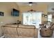 Comfortable living room with a ceiling fan and sliding doors leading to a pool at 3984 Holin Ln, North Port, FL 34287