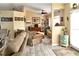 Inviting living room with comfortable seating, ceiling fan, entertainment center, and neutral color palette at 3984 Holin Ln, North Port, FL 34287