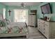 Bright main bedroom features coastal decor, ceiling fan, and sliding glass doors to the lanai at 3984 Holin Ln, North Port, FL 34287
