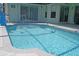 Sparkling screened pool features a fountain, Baja bench and convenient access steps at 3984 Holin Ln, North Port, FL 34287