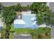 Aerial view of a home displaying its unique roofline, enclosed patio, and landscaped yard at 425 46Th Nw St, Bradenton, FL 34209