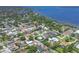 A high-angle aerial view shows a home nestled within a residential area near a bay or lake in a coastal community at 425 46Th Nw St, Bradenton, FL 34209