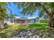 Landscaped yard featuring a screen-enclosed patio, white fence, and lush green grass, perfect for outdoor enjoyment at 425 46Th Nw St, Bradenton, FL 34209
