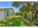 Lush backyard showcasing well-maintained grass and a tall privacy hedge, offering a serene outdoor space at 425 46Th Nw St, Bradenton, FL 34209