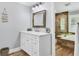 Bright bathroom featuring a modern vanity, decorative mirror, and walk-in shower with wood-look tiling at 425 46Th Nw St, Bradenton, FL 34209