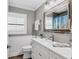 Well-lit bathroom with a modern vanity, wood-trimmed mirror, and beadboard paneling for a classic touch at 425 46Th Nw St, Bradenton, FL 34209
