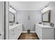 Bathroom featuring dual sinks and vanities and hardwood floors at 425 46Th Nw St, Bradenton, FL 34209