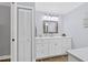 Bathroom featuring built in cabinet and drawers, hardwood floor and custom mirror at 425 46Th Nw St, Bradenton, FL 34209