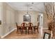 Dining room features an elegant chandelier, hardwood floors, and neutral paint at 425 46Th Nw St, Bradenton, FL 34209