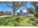 Charming single-Gathering home featuring a white metal roof, lush lawn and mature shade tree at 425 46Th Nw St, Bradenton, FL 34209
