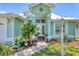 Inviting front entrance with decorative landscaping, mature plants, and decorative exterior lights at 425 46Th Nw St, Bradenton, FL 34209
