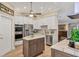 Beautiful kitchen with stainless steel appliances, white cabinets, and a kitchen island for food preparation at 425 46Th Nw St, Bradenton, FL 34209