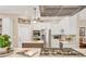 Modern kitchen featuring stainless steel appliances, white cabinets, and a decorative backsplash at 425 46Th Nw St, Bradenton, FL 34209
