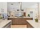 Open-concept kitchen with large island, seating and stainless steel hood and appliances at 425 46Th Nw St, Bradenton, FL 34209