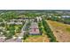 Aerial view of homes in a community with mature trees and landscaping; note the red arrow indicating the subject property at 4740 105Th E Ave, Parrish, FL 34219