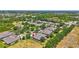 Aerial view of homes in a community with mature trees and landscaping; note the red arrow indicating the subject property at 4740 105Th E Ave, Parrish, FL 34219