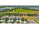 Aerial view of homes in a community with mature trees and landscaping; note the red arrow indicating the subject property at 4740 105Th E Ave, Parrish, FL 34219