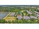 Aerial view of homes in a community with mature trees and landscaping; note the red arrow indicating the subject property at 4740 105Th E Ave, Parrish, FL 34219