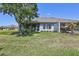 Well-maintained backyard featuring a screened patio with views of the surrounding landscape and clear blue sky at 4740 105Th E Ave, Parrish, FL 34219