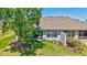 The home's exterior features a screened-in lanai and lush backyard with mature trees at 4740 105Th E Ave, Parrish, FL 34219
