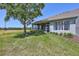 View of backyard featuring a screened-in porch, lush lawn, and scenic view of the adjacent water feature at 4740 105Th E Ave, Parrish, FL 34219