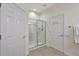 Clean bathroom featuring a glass-enclosed shower, white doors and neutral tile floors at 4740 105Th E Ave, Parrish, FL 34219