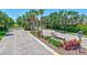 Community entrance with manicured landscaping, mature palm trees, and secure gated access to the neighborhood at 4740 105Th E Ave, Parrish, FL 34219