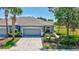 Charming home featuring a well-manicured lawn, mature landscaping, and a two-car garage at 4740 105Th E Ave, Parrish, FL 34219