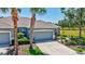 Charming home boasting lush tropical landscaping, a well-manicured lawn, and a spacious driveway at 4740 105Th E Ave, Parrish, FL 34219